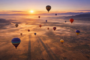 Hot Air Balloon Festival at Sunrise Over Mountain Landscape Free 4K Desktop Background