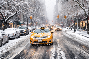 Snowy City Street with Yellow Taxi - Free Winter Wallpaper for Desktop and Mobile