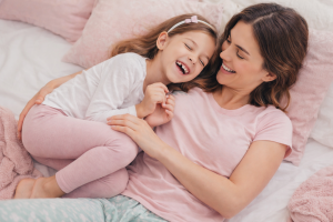 Mom and Daughter Laughing Pink Pajamas Cute Bedroom Wallpaper for Desktop
