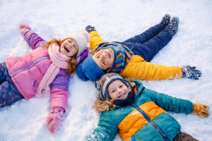 Three Happy Kids Playing in Winter Snow - Free High-Resolution Desktop Background