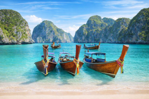 Beautiful Tropical Paradise with Longtail Boats on Crystal Clear Blue Water - Free Desktop Wallpaper