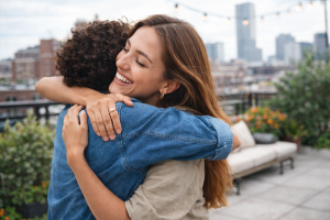 Happy Couple Hugging in Cityscape